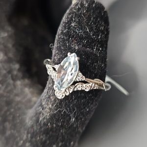 A-4 Silverstone ring with light blue stone and clear accents